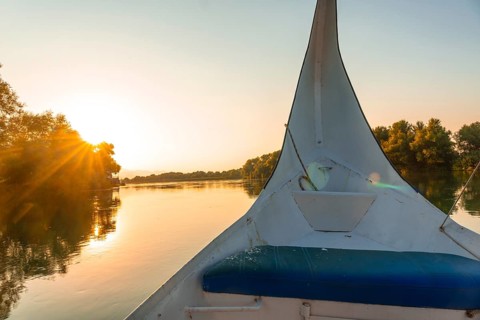 Sunset sailing on the lake in a traditional boat on a sightseeing excursion from Shkoder in Shiroka. Albania