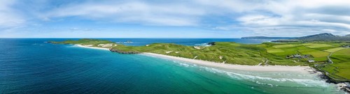 Aerial panorama of Balnakeil Bay with sandy beach and dunes on the right