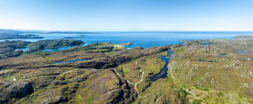 Aerial panorama of the sparsely populated Northwest Highlands with the single track road and pass road B869