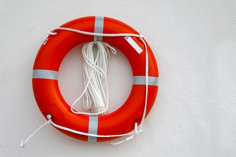 Life belt on white house wall