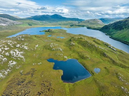 Aerial view of the freshwater loch Loch Stack with surrounding boggy pools in the Northern Highlands
