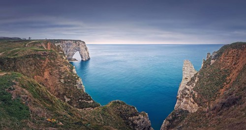 Beautiful panorama of the Porte d'Aval natural arch at Etretat famous cliffs