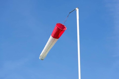 White-red windsock against blue sky