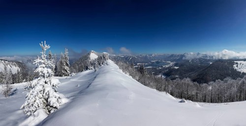 Winter landscape covered in deep snow in the Osterhorn group with a view from Pillstein to Zwoelferhorn