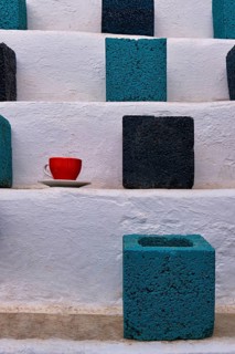 Close frontal shot of cubic flower pots in turquoise and black colors