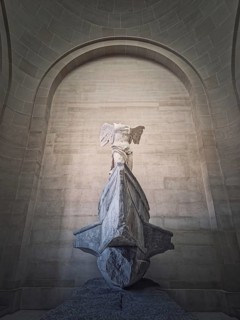Winged Victory of Samothrace statue in the hall of Louvre museum
