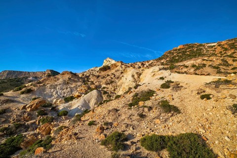 Unique natural rock formations of yellow and orange cliffs in low sunlight