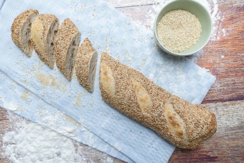 Freshly baked vegan baguette with sesame seeds