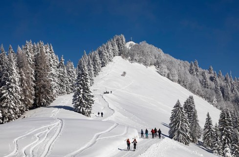 Deep snowy winter landscape with ski tourers on the way to the Zwoelferhorn