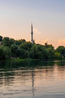 View of Kisha Katolike Eternit Capucin from a boat on a sightseeing excursion on Lake Shkoder in Shiroka. Albania