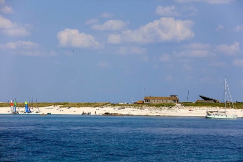 Sandy beach beach of the island Ile de Penfret with sailing school Les Glenans