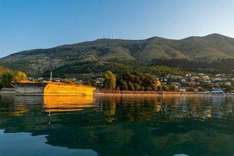 View of the city of Shiroka from the lake on a traditional boat on a sightseeing excursion from Shkoder. Albania