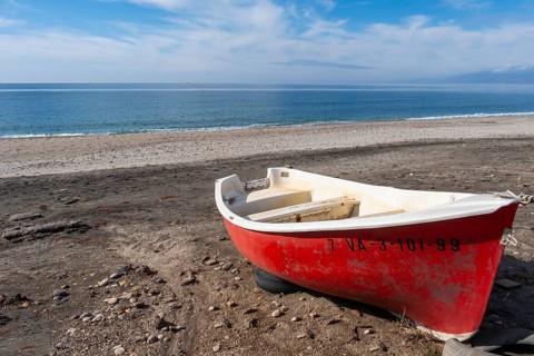 Red boat on Las Salinas de Cabo de Gata beach
