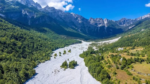 Aerial drone view of Valbona valley and dry river in summer