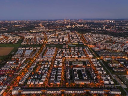 The lights of the buildings and street lamps in Frankfurt's Riedberg district shine in the evening