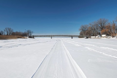 Vehicle tracks on snow covered frozen river