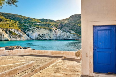 Sunny summer landscape on Greek island. Traditional whitewashed terrace