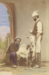 Two men with a goat