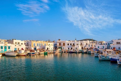 Traditional Greek fishing village and harbour on sunny day