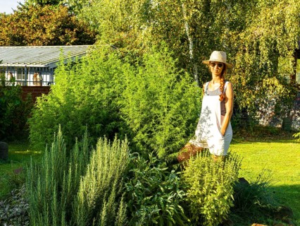 Woman in herb bed