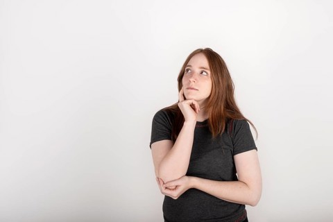 Portrait of a young red haired woman on a white background