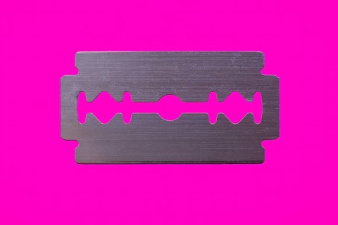 Razor blade against magenta background