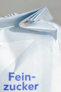 A food moth sticks to the inside of the fold of a food packaging in a cocoon