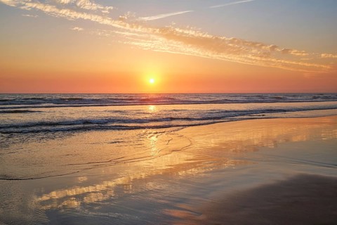 Atlantic ocean sunset with surging waves at Fonte da Telha beach
