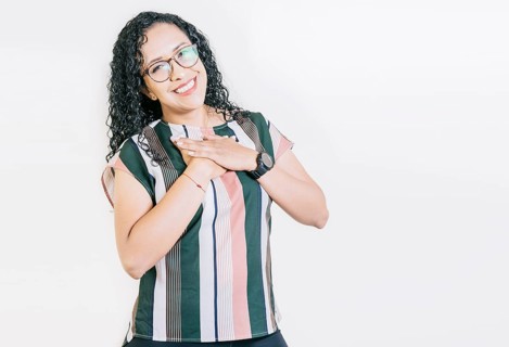 Grateful young woman smiling with hands on chest isolated. Positive smiling girl with hands on chest. Grateful people with hands on chest