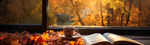 Cup and open book resting on window sill with a fall mountain country view banner