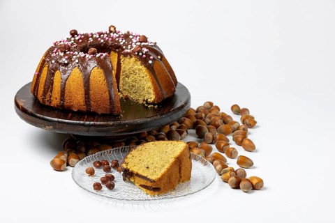 Vegan hazelnut cake on wooden serving plate