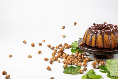 Vegan hazelnut cake on wooden serving plate