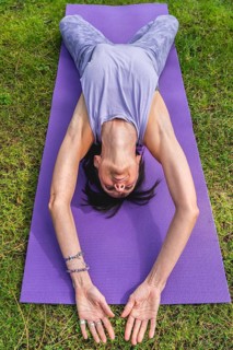 Hihg angle view of a woman lying on a yoga block to improving posture
