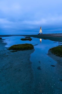 Kugelbake illuminated with water reflection at dusk