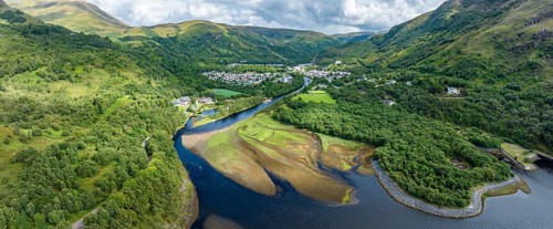 Aerial panorama of the village of Kinlochleven with the mouth of the River Leven at the eastern part of the freshwater loch Lochleven
