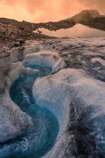 Meltwater stream on the glacier at sunset