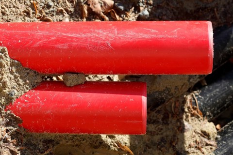 Red pipes in the sand on a construction site
