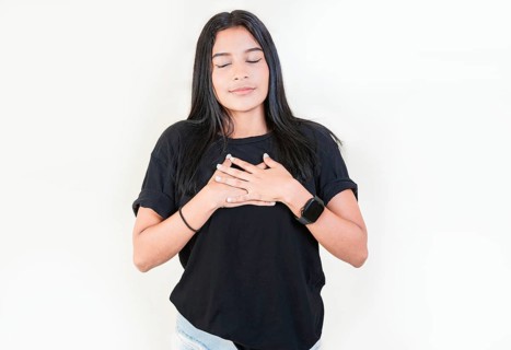 Thankful people with hands on chest. Grateful teenage girl smiling with hands on chest isolated. Positive latin girl with hands on chest