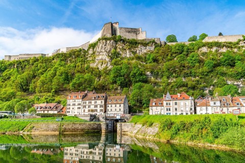 Houses at the foot of Mount Saint Etienne with the World Heritage Site of the Citadel of Besancon on the Doubs River