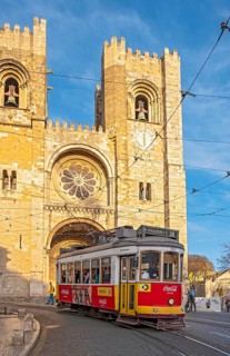 Tram passes by Lisbon Se Cathedral