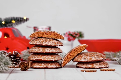 Stacks with halved traditional German round glazed gingerbread Christmas cookie called 'Lebkuchen' with seasonal decoration