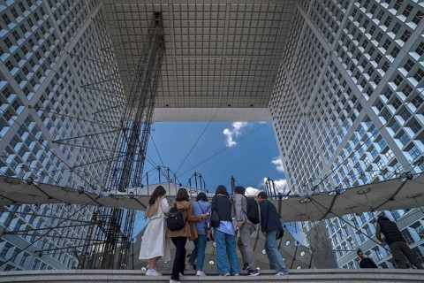 Tourists take a souvenir photo in the Grand Arche