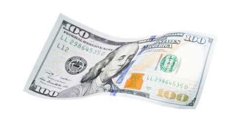 One hundred dollar bill falling or floating on empty background