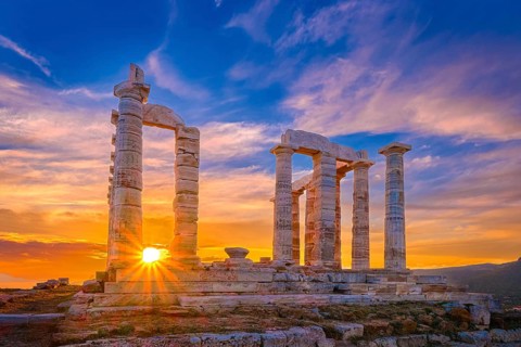 Beautiful sunset sky and ancient ruins of temple of Poseidon