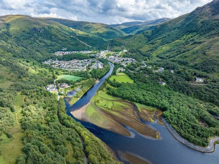 Aerial view of the village of Kinlochleven with the mouth of the River Leven at the eastern part of the freshwater loch Lochleven