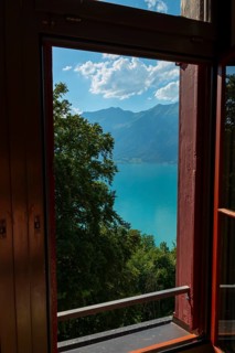 Window View from The Historical Grandhotel Giessbach with View over Mountain and Lake Brienz with Sunlight in Giessbach