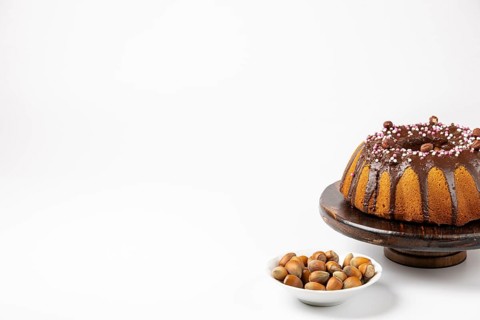 Vegan hazelnut cake on wooden serving plate