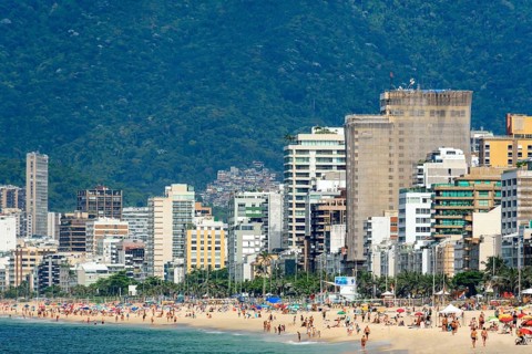 Summer day in the city of Rio de Janeiro with Ipanema beach occupied by city residents and tourists