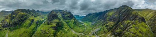 Aerial panorama of the prominent mountain range and the three peaks of Three Sisters of Glen Coe