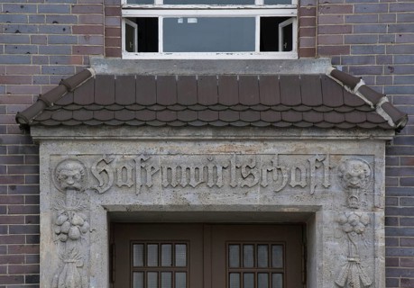 Lettering on a heritage-protected building commemorates its former use as a port economy